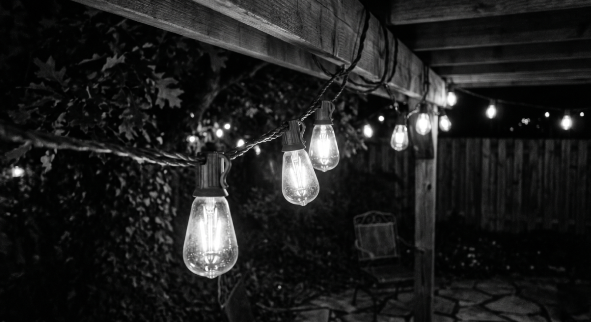 String lights glowing on a patio at night